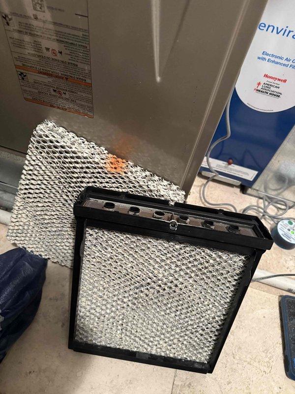 Completed comprehensive maintenance on three furnace systems and associated humidifiers as part of annual agreement service. Replaced air filters including two 20x20x4 filters and one 16x25x4 filter, which showed significant accumulation of dirt, debris, and discoloration. Inspected Carrier furnace unit, ductwork connections, PVC condensate drainage system, and all associated HVAC components to ensure proper operation and system integrity.