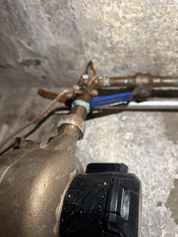 Completed comprehensive fall heating tune-up and safety inspection on 90% efficiency boiler system. Performed thorough examination of heat exchanger for cracks and deterioration, tested all safety controls for proper operation, and verified exhaust vent functionality. Conducted home carbon monoxide testing to ensure safe operation. Cleaned burner and pilot assemblies, inspected blower motor and wheel for debris accumulation, and cycled all operating controls to verify proper function. Inspected natural gas lines for detectable leaks, examined line voltage switches and wiring for safety compliance, and assessed system for presence of dirt, mold, or mildew. Tested indoor relative humidity levels. Thermostat displaying proper temperature reading of 70°F with clear digital display. Observed aged copper plumbing components with corrosion and patina present on piping. All safety systems operational and unit ready for heating season.