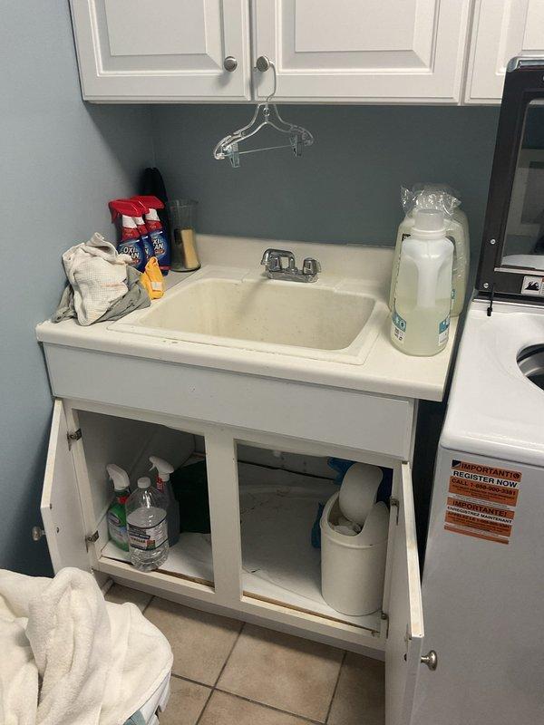 Completed comprehensive plumbing inspection of residential property, examining all accessible fixtures, drains, and supply lines throughout the home. Inspected utility sink and cabinet plumbing in laundry area, verifying proper drainage and supply connections. Examined kitchen sink plumbing system including InSinkErator Pro 850-T garbage disposal unit, associated drain lines, flexible supply connections, and white PVC drainage piping for leaks or deterioration. Verified water filtration system connections and proper operation. Replaced two 16x25x4 air filters on HVAC furnace units as part of routine maintenance. All plumbing fixtures, connections, and drainage systems found to be functioning properly with no leaks or issues identified during inspection.