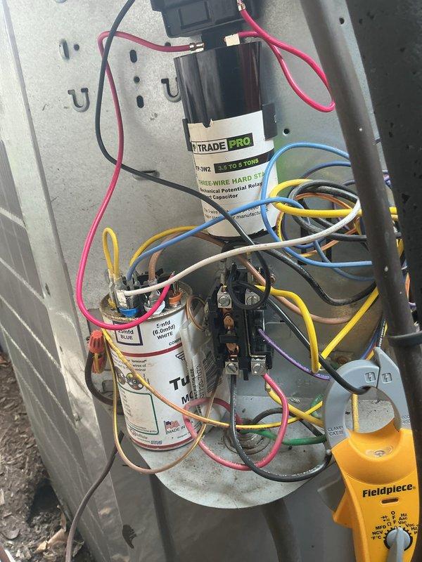 Replaced failed contactors on both outdoor condensing units to restore proper compressor operation. Installed TRADE PRO hard start capacitors (compressor savers) rated for 2.5-5 ton systems on Unit 1 and Unit 2 to reduce startup amperage draw and extend compressor lifespan. Verified proper electrical connections, tested all components with diagnostic equipment, and confirmed both Carrier units are operating within manufacturer specifications.
