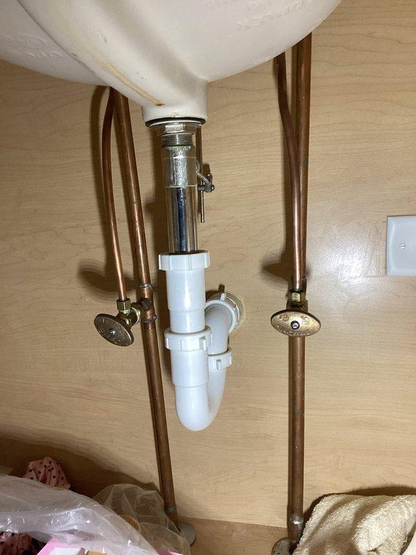Completed comprehensive whole home plumbing inspection with primary focus on reported basement leak and bathroom faucet concerns. Thoroughly examined under-sink plumbing assembly including chrome drain assembly, PVC P-trap configuration, and copper supply lines with shut-off valves, confirming all connections were secure and functioning properly. Inspected bathroom fixtures, vanity plumbing, and surrounding areas for moisture intrusion, leaks, or potential issues requiring attention.