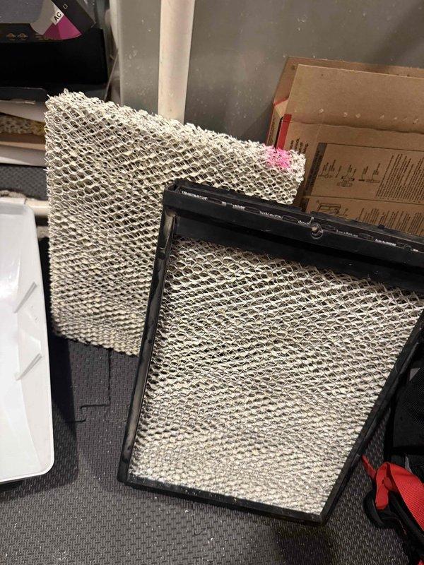 Completed comprehensive maintenance on furnace and humidifier system per maintenance agreement #35. Performed standard cleaning and inspection procedures, verified system operation with digital temperature measurements showing proper functionality at 1.1 degrees differential, and replaced humidifier evaporator pads with new honeycomb-structured filters in black frames to ensure optimal humidity control and air quality for the upcoming heating season.