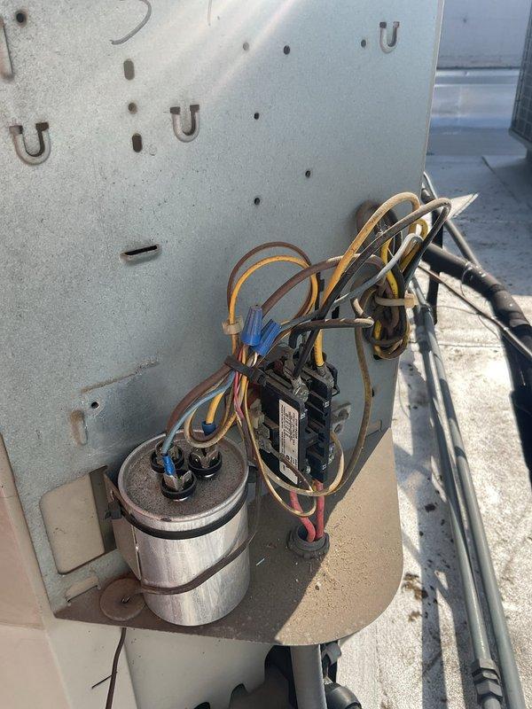 Performed scheduled maintenance on the gas furnace, air conditioning system, and water heater under the maintenance agreement. Inspected the furnace burner assembly, gas valve, flame sensor, and wiring, verifying stable blue burner flames and proper ignition operation. Inspected the outdoor condenser's electrical compartment, including the run capacitor, contactor, and wiring connections, and documented heavy dust and grime accumulation on the components.
