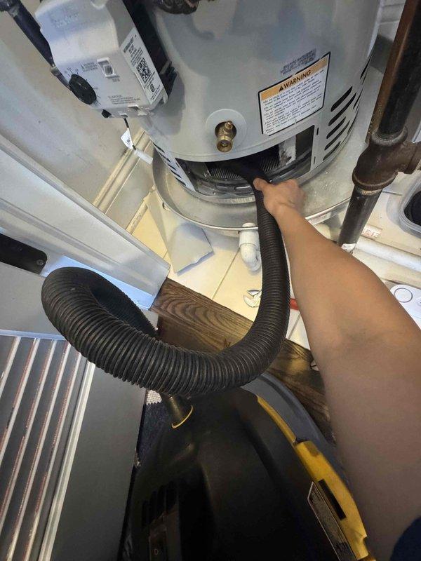 Performed scheduled maintenance on the furnace, humidifier, and gas water heater under the service agreement. Inspected and cleaned the furnace flame sensor and ignition assembly, confirmed secure mounting, and found no cracks or damage. Vacuumed soot and debris from the water heater burner compartment and base, and noted corrosion on the adjacent steel pipe for monitoring.