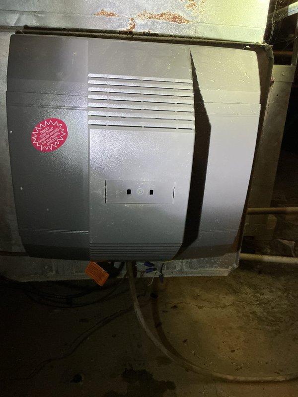 Performed scheduled maintenance on two furnaces and two whole-house humidifiers under the service agreement; media filters were excluded from scope. Inspected the basement mechanical space and crawl space access, and documented rust and corrosion on the ductwork above one humidifier along with moisture spotting on the unit housing, loose wiring with exposed connectors, and staining on the floor and access steps, which should be evaluated for possible water leakage or excess condensation.