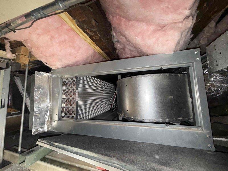 Responded to a no-cooling call on a 5-year-old split system and inspected the attic-mounted air handler, where the control board displayed a "STANDBY – FLOAT SW FAULT" code, indicating the condensate overflow safety switch had tripped and locked out cooling operation. The evaporator coil and cabinet showed no signs of frost, ice, or corrosion, and the blower assembly appeared intact. Addressed the float switch fault condition to restore normal operation and ensure proper condensate drainage and system cooling.