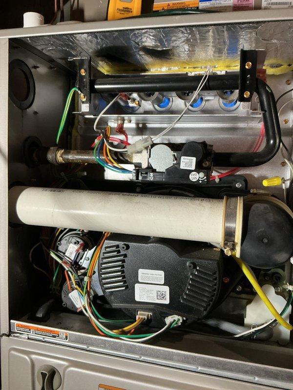 Performed annual maintenance on two gas furnaces, a whole-house humidifier, and a water heater, including replacement of the 16x25x4 media filters and servicing of the humidifier pad (#35). During inspection, heat discoloration and soot scorching were observed on the upper cabinet insulation of one furnace, and borescope inspection of the heat exchanger passage revealed a crumpled foreign object near the far end; recommend further evaluation of combustion and venting performance and heat exchanger integrity.