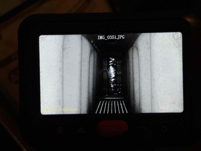 Performed annual maintenance on two gas furnaces, a whole-house humidifier, and a water heater, including replacement of the 16x25x4 media filters and servicing of the humidifier pad (#35). During inspection, heat discoloration and soot scorching were observed on the upper cabinet insulation of one furnace, and borescope inspection of the heat exchanger passage revealed a crumpled foreign object near the far end; recommend further evaluation of combustion and venting performance and heat exchanger integrity.