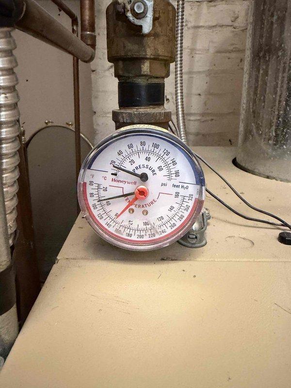 Performed annual maintenance on the furnace, boiler, and two humidifiers, including replacement of the 16x25x1 return air filter and inspection of the boiler's combination pressure/temperature gauge, which was found reading within normal operating range. Both humidifiers were serviced, with the heavily soiled and mineral-scaled evaporator pads cleaned or replaced and the drain lines checked; corrosion and rust deposits were noted at the base of one humidifier unit and recommended for ongoing monitoring. All systems were verified for proper operation at completion.