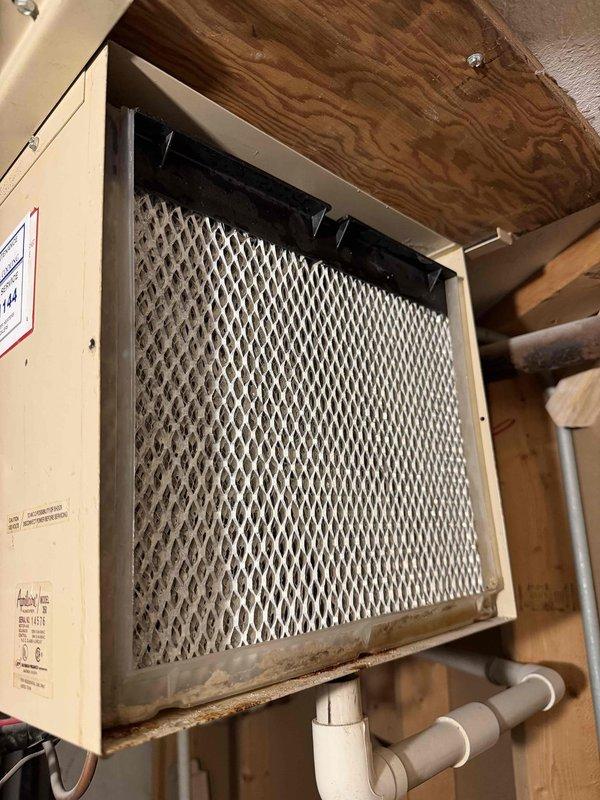 Performed annual maintenance on the furnace, boiler, and two humidifiers, including replacement of the 16x25x1 return air filter and inspection of the boiler's combination pressure/temperature gauge, which was found reading within normal operating range. Both humidifiers were serviced, with the heavily soiled and mineral-scaled evaporator pads cleaned or replaced and the drain lines checked; corrosion and rust deposits were noted at the base of one humidifier unit and recommended for ongoing monitoring. All systems were verified for proper operation at completion.