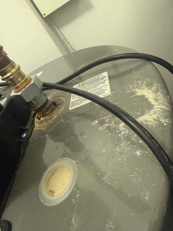 Performed scheduled maintenance on the furnace, including replacement of the 16x25x1 filter, and verified ambient carbon monoxide at the unit at 2 ppm, within safe limits. Inspection of the adjacent water heater revealed heavy corrosion and mineral deposits at the top fitting connection with moisture present, indicating an active leak; recommend further evaluation and repair or replacement of the water heater.