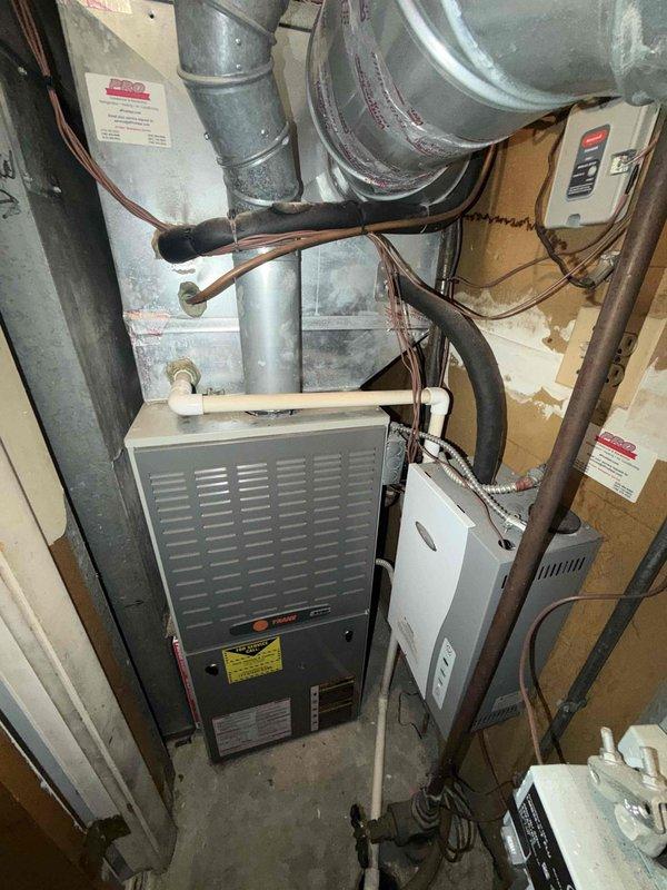 Performed a seasonal tune-up on a 16-year-old Trane gas forced-air furnace, including inspection of the heat exchanger, blower assembly, and cabinet interior. Noted rust and corrosion with dust buildup on internal components, particularly around the blower housing and cabinet base, and recommend continued monitoring of the heat exchanger and cabinet condition given the unit's age.
