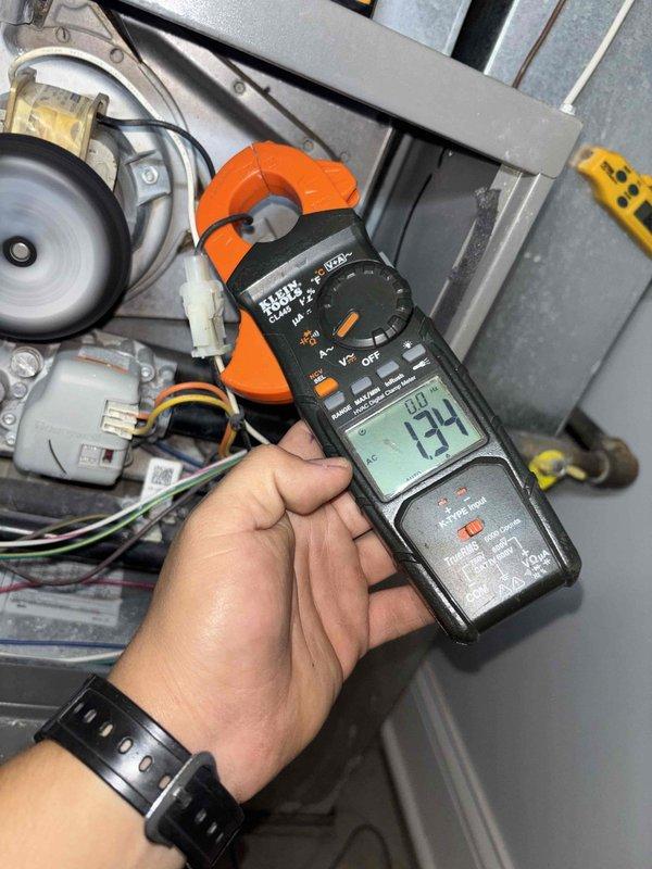 Performed a seasonal heating tune-up on a 9-year-old furnace, including inspection of the burner assembly, gas valve, blower motor, and electrical connections, with amperage measured on the control circuit using a clamp meter. Used a borescope to visually inspect the internal cabinet and ductwork, noting minor reddish-orange discoloration consistent with surface rust but no obvious damage. Equipment was found operating within normal parameters and ready for the heating season.