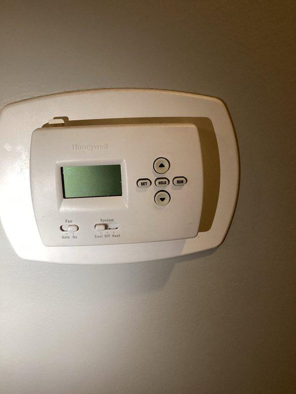 Responded to a call for a Honeywell thermostat with a blank display and no temperature adjustment. Inspected the thermostat and verified the unit was unresponsive. Measured supply air temperature at the duct at 56.1°F to confirm system operation and cooling performance.