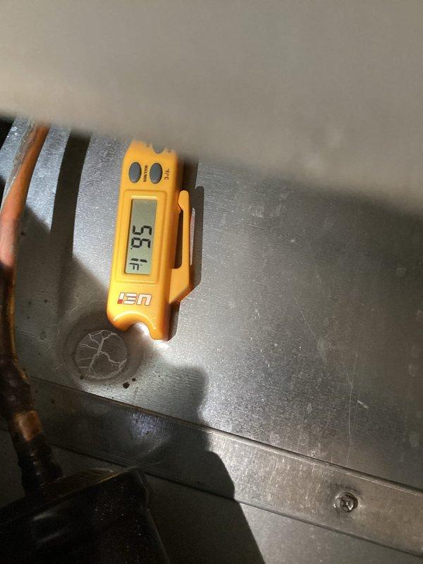 Responded to a call for a Honeywell thermostat with a blank display and no temperature adjustment. Inspected the thermostat and verified the unit was unresponsive. Measured supply air temperature at the duct at 56.1°F to confirm system operation and cooling performance.
