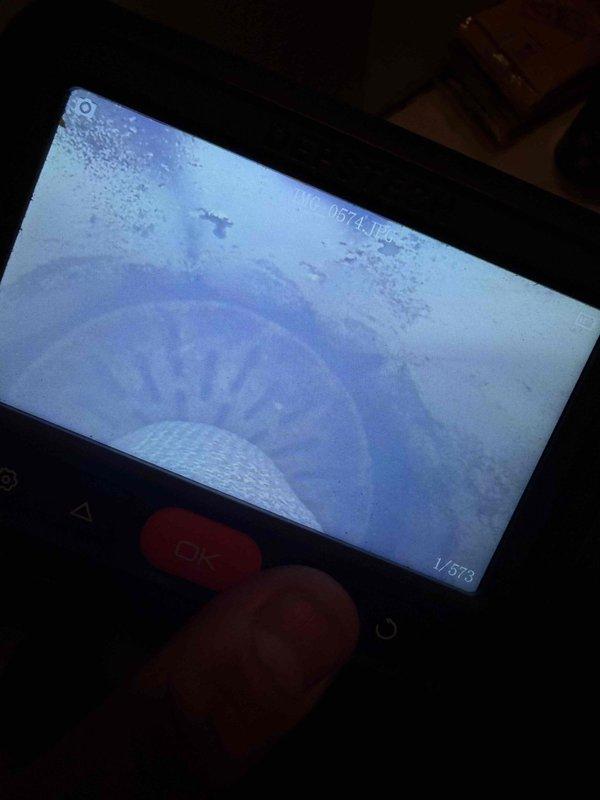 Responded to a callback for a radiant heat system not operating following recent repairs. Performed a visual inspection using a borescope camera of the internal piping and heat exchange components, documenting the interior conditions with images and identifying debris and frost-like buildup on interior surfaces that may be affecting system performance. Findings were recorded to support further diagnosis and corrective action.