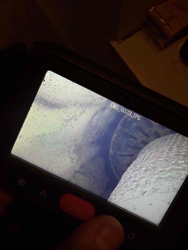 Responded to a callback for a radiant heat system not operating following recent repairs. Performed a visual inspection using a borescope camera of the internal piping and heat exchange components, documenting the interior conditions with images and identifying debris and frost-like buildup on interior surfaces that may be affecting system performance. Findings were recorded to support further diagnosis and corrective action.