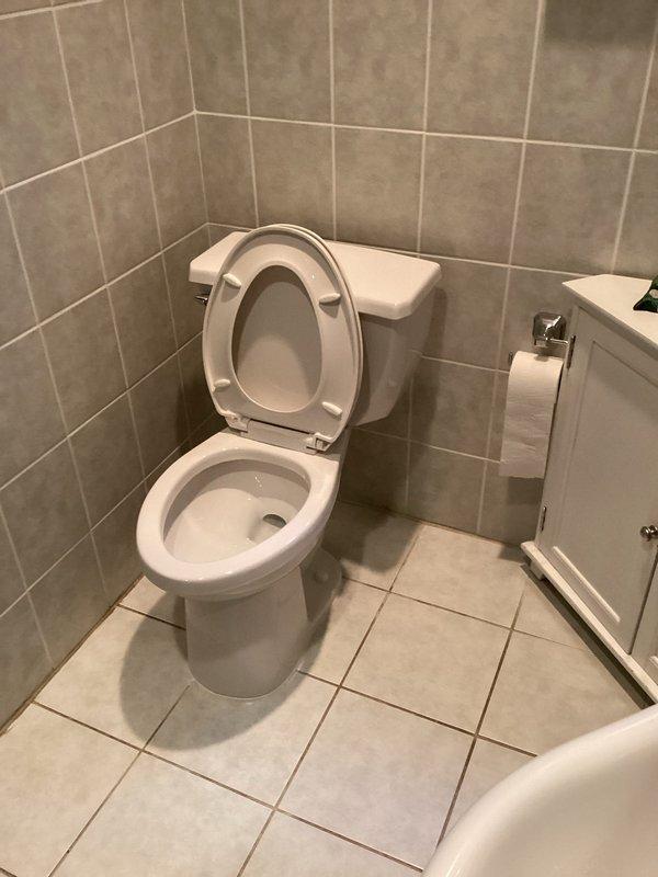 Repaired the toilet flange and cleared the main drain line with a drain rod to restore proper flow. Installed a new two-piece toilet, secured it to the repaired flange with a new wax seal, and tested for proper flushing, stable seating, and leak-free operation.