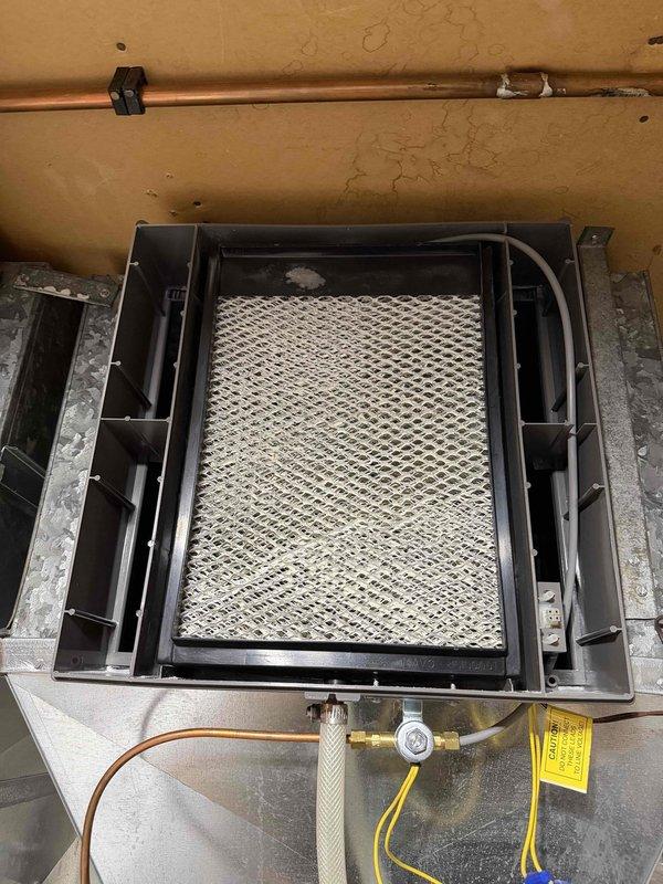 Performed scheduled maintenance on two furnaces and two whole-house humidifiers, inspecting and cleaning the blower assemblies, which were found free of rust, frost, and heavy debris. Serviced the humidifiers, noting mineral scale on the evaporator pads, and checked the water supply lines, fittings, valves, and electrical connections for proper operation (filter media not included).