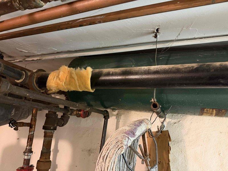 Responded to a reported gas odor at the boiler and inspected the unit and associated gas piping. Removed the pilot assembly, which showed heavy soot accumulation and discoloration, for service and cleaning of the burner and pilot components. The system was checked for leaks and safe operation prior to being returned to service.