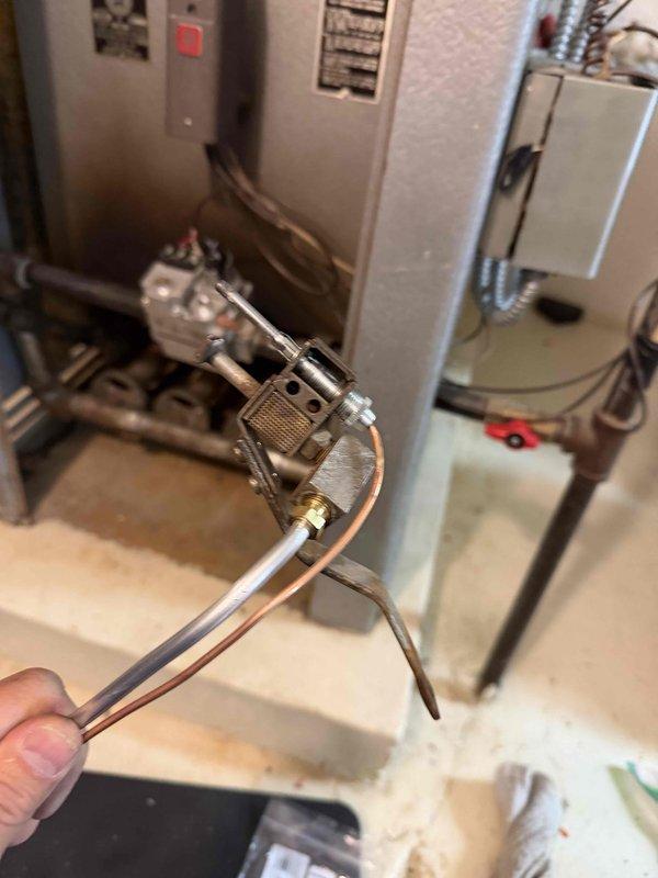 Responded to a reported gas odor at the boiler and inspected the unit and associated gas piping. Removed the pilot assembly, which showed heavy soot accumulation and discoloration, for service and cleaning of the burner and pilot components. The system was checked for leaks and safe operation prior to being returned to service.