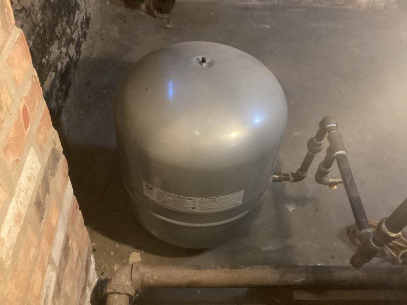 Performed annual maintenance on the natural gas-fired boiler system under the service agreement, inspecting the expansion tank, circulator pump assembly, and associated piping and fittings. Documented corrosion on the supply piping and worn paint on the circulator pump body and flange, and found the system components otherwise in serviceable operating condition.