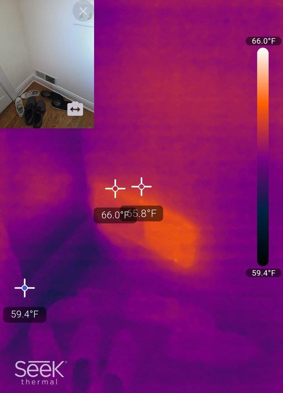 Responded to a complaint of elevated indoor humidity at the thermostat (67% RH), following a prior visit where a full diagnostic could not be completed due to ongoing renovations, which have since finished. Verified thermostat humidity readings against calibrated handheld psychrometers and performed thermal imaging of the area near the floor register, which revealed a localized cool zone in the affected corner, indicating a potential air distribution or moisture issue. Documented findings with thermal and visual images for further evaluation of airflow, duct performance, and dehumidification capacity.