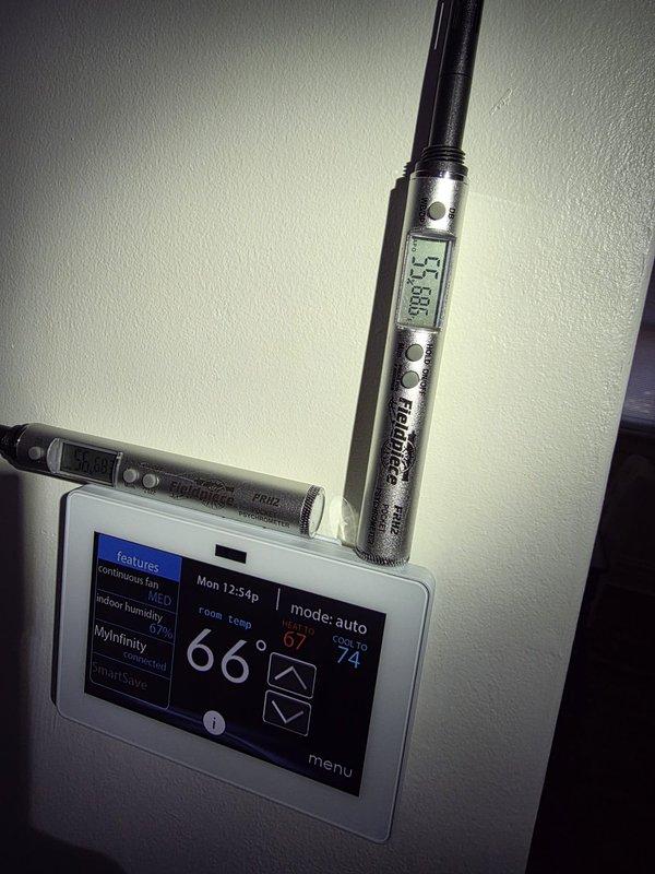 Responded to a complaint of elevated indoor humidity at the thermostat (67% RH), following a prior visit where a full diagnostic could not be completed due to ongoing renovations, which have since finished. Verified thermostat humidity readings against calibrated handheld psychrometers and performed thermal imaging of the area near the floor register, which revealed a localized cool zone in the affected corner, indicating a potential air distribution or moisture issue. Documented findings with thermal and visual images for further evaluation of airflow, duct performance, and dehumidification capacity.
