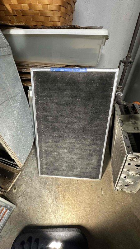 Performed scheduled maintenance on a Bosch gas furnace, including inspection of the unit, flue venting, and condensate piping. Removed the heavily soiled, dust-laden air filter and installed a new fiberglass disposable filter to restore proper airflow and protect the blower and heat exchanger components.
