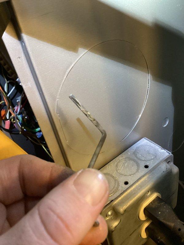 Responded to a no-heat call on a 7-year-old gas furnace and opened the cabinet to inspect the gas valve, pressure switches, inducer assembly, and control wiring. Used a clamp meter in µA/DC mode to test flame sensor circuit current (reading 0.0 µA, indicating no flame signal), and inspected the wiring harness and panel/junction box area for faults, with no visible damage, corrosion, or loose connections observed. Heating system was diagnosed for flame sensing and ignition sequence issues.