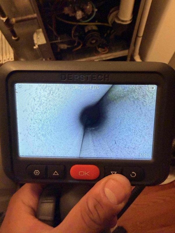 Performed a furnace clean and check under the maintenance agreement, inspecting the blower assembly, control wiring, and condensate PVC piping within the cabinet. Used a borescope to visually inspect the interior of the duct/piping for obstructions or buildup, and documented findings with photos. Unit inspected and serviced with no additional work performed.