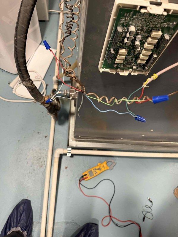Responded to a no-heat call where the thermostat displayed only a cooling option. Diagnosed with a clamp meter and found the air handler's control board partially detached from the cabinet with several low-voltage wires (R, W, G, Y, C) disconnected and loosely twisted together, interrupting the heat call. The Triangle Tube Prestige boiler was also displaying an E.04 fault code. Inspected the control board, wiring, and boiler display, and documented the findings; recommended repair of the control board and low-voltage wiring and further evaluation of the thermostat and boiler fault.