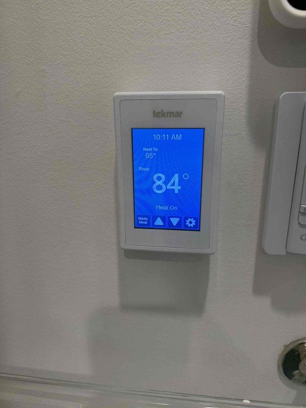 Responded to a callback for a radiant heating system reported as non-functional following prior service. Verified the Tekmar thermostat was calling for heat with a 95° setpoint, and the floor sensor reading rose from 81° to 84° over roughly six minutes, confirming the radiant system is actively heating and operating normally.