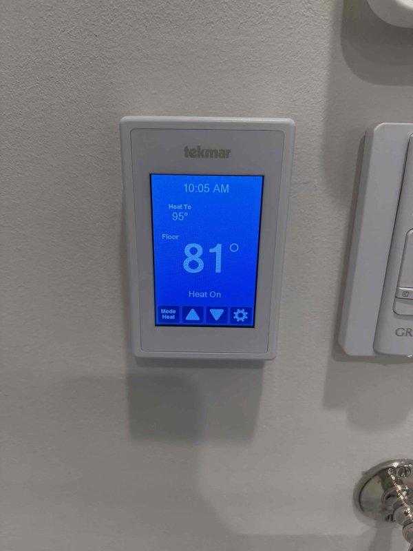 Responded to a callback for a radiant heating system reported as non-functional following prior service. Verified the Tekmar thermostat was calling for heat with a 95° setpoint, and the floor sensor reading rose from 81° to 84° over roughly six minutes, confirming the radiant system is actively heating and operating normally.