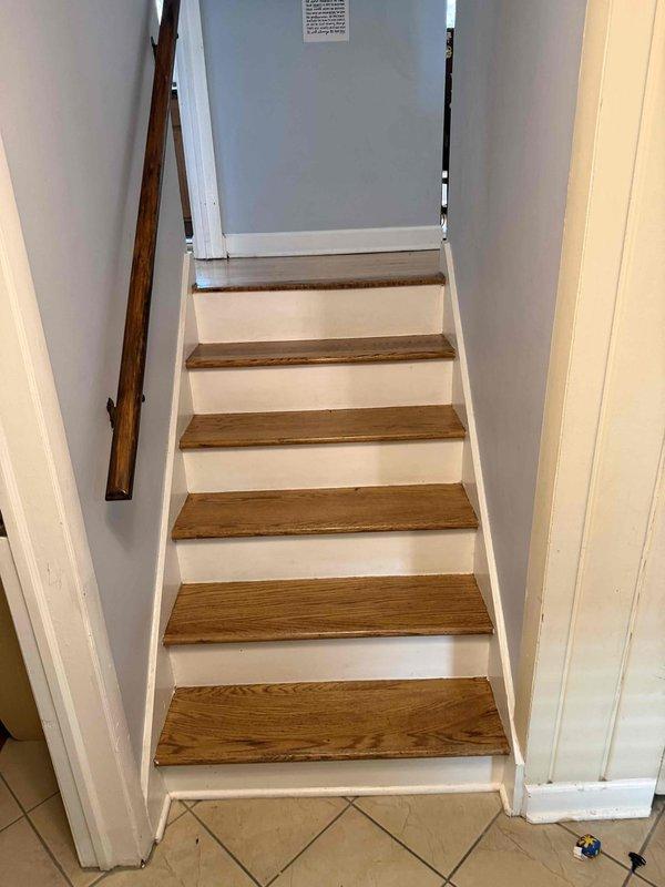Evaluated a 9-year-old gas furnace in a utility closet for replacement, inspecting the flue venting, plenum and ductwork, condensate drain line, and electrical connections, with no significant rust, frost, or damage observed. Assessed the existing installation and access routes, including the staircase leading to the equipment space, to prepare a replacement quote.