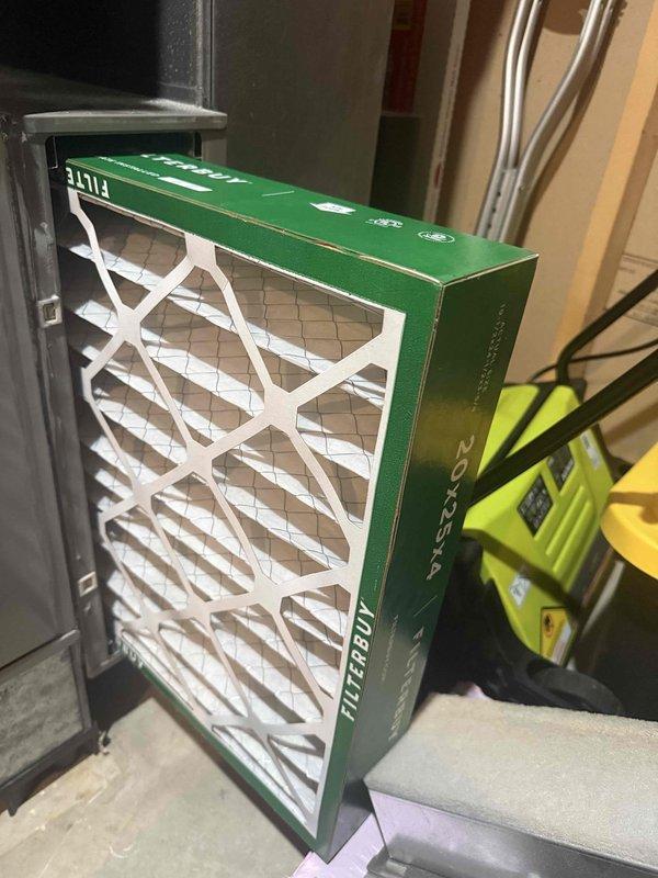 Performed scheduled maintenance on two furnaces and their associated humidifiers, replacing the 20x25x4 media air filter with a new pleated unit that seated properly in the air handler cabinet. Inspected the blower wheel and housing, finding intact metal surfaces with no rust, cracks, or ice and only a light film of dust on the vanes.