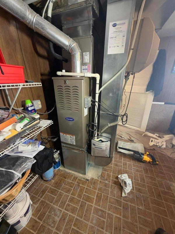 Removed the existing furnace and installed a new Carrier upright gas furnace, connecting it to the existing supply plenum and galvanized ductwork, flue venting, PVC condensate drain, and electrical supply with a properly secured junction box. Sealed duct connections, verified system operation, and left the equipment area clean with no visible damage or leaks.