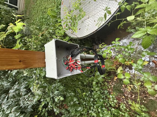 Upon arrival, I met with the customer, who directed me to the affected septic system that was reportedly backing up. Upon inspection, I confirmed that both the septic tank and the pump station were intact but completely full. I then began troubleshooting the power supply to the pumps to determine the cause of failure. At the junction box located next to the pump station, I discovered a serious hazard: the box was left wide open, with a nest of exposed wires twisted together and making contact with one another.

Tracing the issue back to the building, I located the pump control panel. Upon opening the panel, I found that a bird had entered the box, built a nest, and unfortunately died after becoming entangled in the wiring. With the breakers flipped off, it was determined that the entire wiring system presents a significant safety hazard. For this reason, we strongly recommend that all wiring associated with the pump system be replaced.