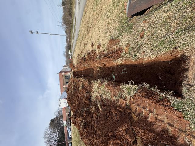 Installed new underground PVC water service line from meter to building, including trenching, bedding, and preparation for backfill.