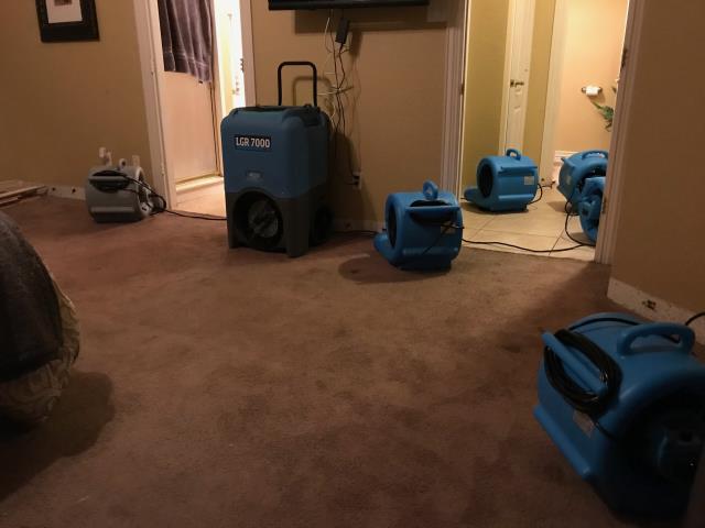 Starting mitigation for a water damage at a home in Arlington, Texas after a water heater flooded the bathroom, bedroom, hallway and closet.