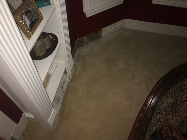 Inspecting water damage after rising water flooded the house of a family in Southlake, Texas.