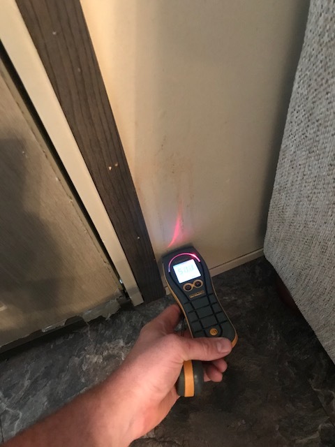 Inspecting water damage at a home in Grapevine, Texas after heavy rain caused water to leak onto walls and ceiling.