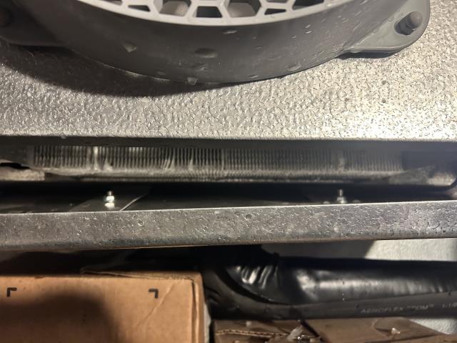 Technician arrived and was shown to walk in freezer. Found freezer pan to be completed iced up and not draining causing water build up and spills everywhere. Began de icing the coil with the defrost setting and some hot water. Once all ice was thawed out i started checking all the heaters to make sure they were all turning on. Found all heaters to be good and in working order. I started checking the pipe heater and found it to be about an inch away from pan causing ice to build up and block the pipe. Moved the heater up more and checked that it was heating the whole fitting. Once confirmed i checked the settings and found that they were done all wrong. I fixed the settings and added more time to defrost and for it to sense when it needs it not a timely schedule. The unit has been fixed and walk in freezer is bringing down the temperature