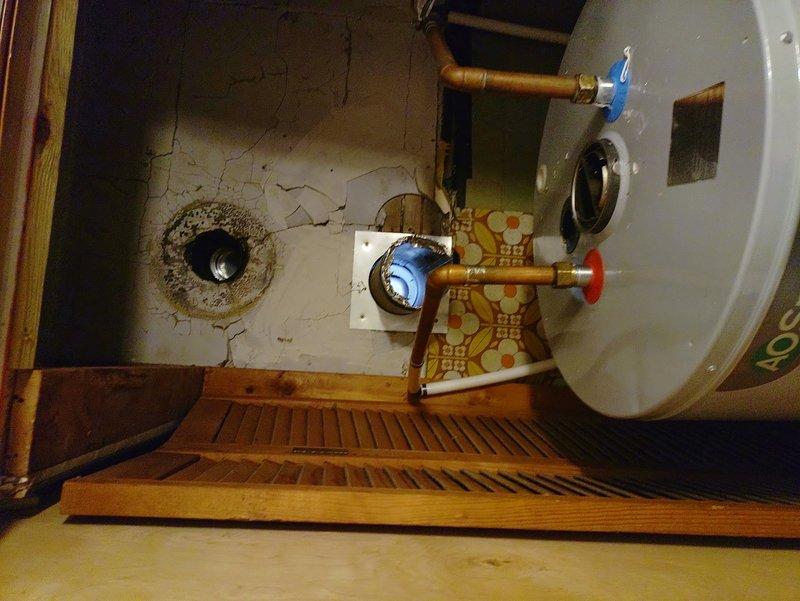 Performed diagnostics on non-lighting hot water tank. Verified proper gas flow, cleaned pilot assembly and ignition components. Successfully re-lit pilot and confirmed stable flame, restoring hot water functionality. Noted significant wall deterioration around plumbing connections that should be addressed in future service.