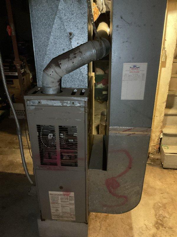 Completed comprehensive inspection of existing furnace system in basement utility area, documenting current installation configuration including main unit, air handler, ventilation components, and ductwork connections. Assessment revealed aging equipment with flexible metallic S-shaped ductwork that requires replacement. Prepared estimate for complete furnace system replacement with modern, energy-efficient alternative.