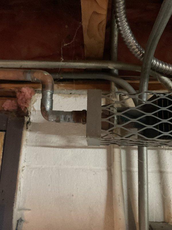 Evaluated basement heating system for relocation of two boiler registers. Inspected existing copper piping, flexible metal ducting, and connections to blue boiler unit with attached expansion tanks. Provided quote for register relocation work, including necessary modifications to existing ductwork.
