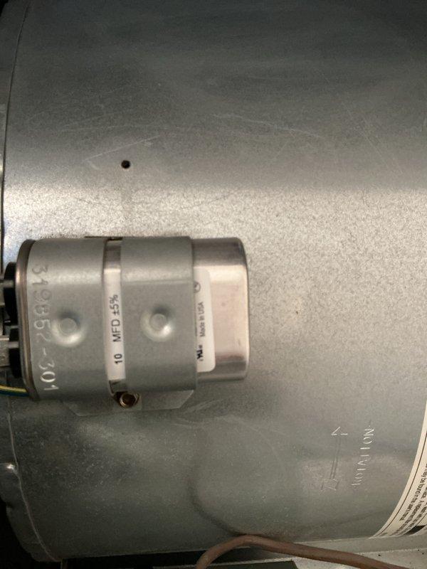 Performed complete furnace maintenance inspection as requested. Inspected blower assembly and fan housing for proper operation. Examined capacitor (marked "MFD 5%") and related electrical components to verify system functionality. All components operating within normal parameters.