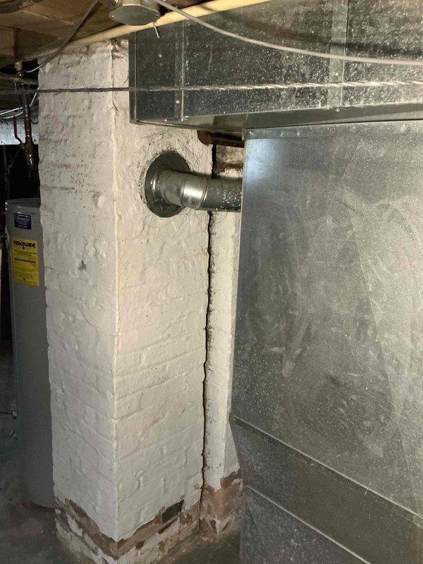 Responded to tenant's no heat complaint at rental property. Performed diagnostic inspection on Lennox WatchGuard furnace system. Found deterioration at base of white brick exhaust column affecting proper venting. Cleaned connections and restored proper heat function. System now operating normally.