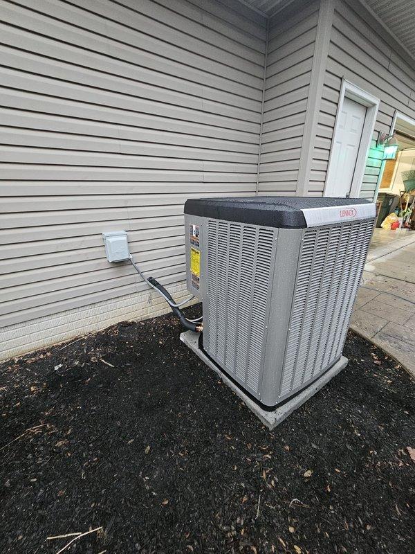 Successfully installed a complete Dave Lennox Signature Series HVAC system including outdoor condenser unit positioned on concrete pad with proper electrical connections, and indoor furnace/air handler with associated ductwork and PVC ventilation pipes in utility area. System installed to manufacturer specifications with all necessary connections to existing gas line and electrical service.