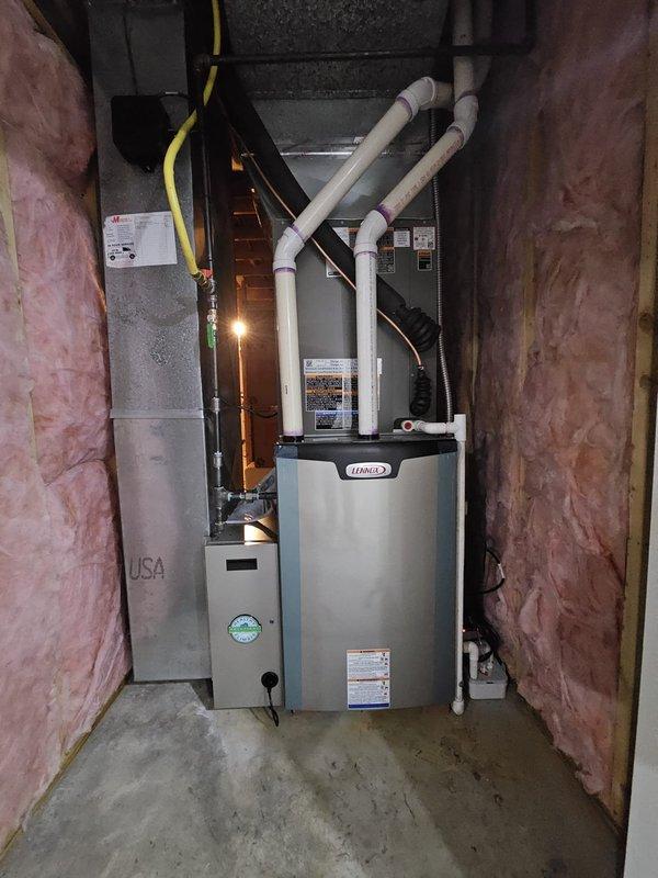 Successfully installed a complete Dave Lennox Signature Series HVAC system including outdoor condenser unit positioned on concrete pad with proper electrical connections, and indoor furnace/air handler with associated ductwork and PVC ventilation pipes in utility area. System installed to manufacturer specifications with all necessary connections to existing gas line and electrical service.